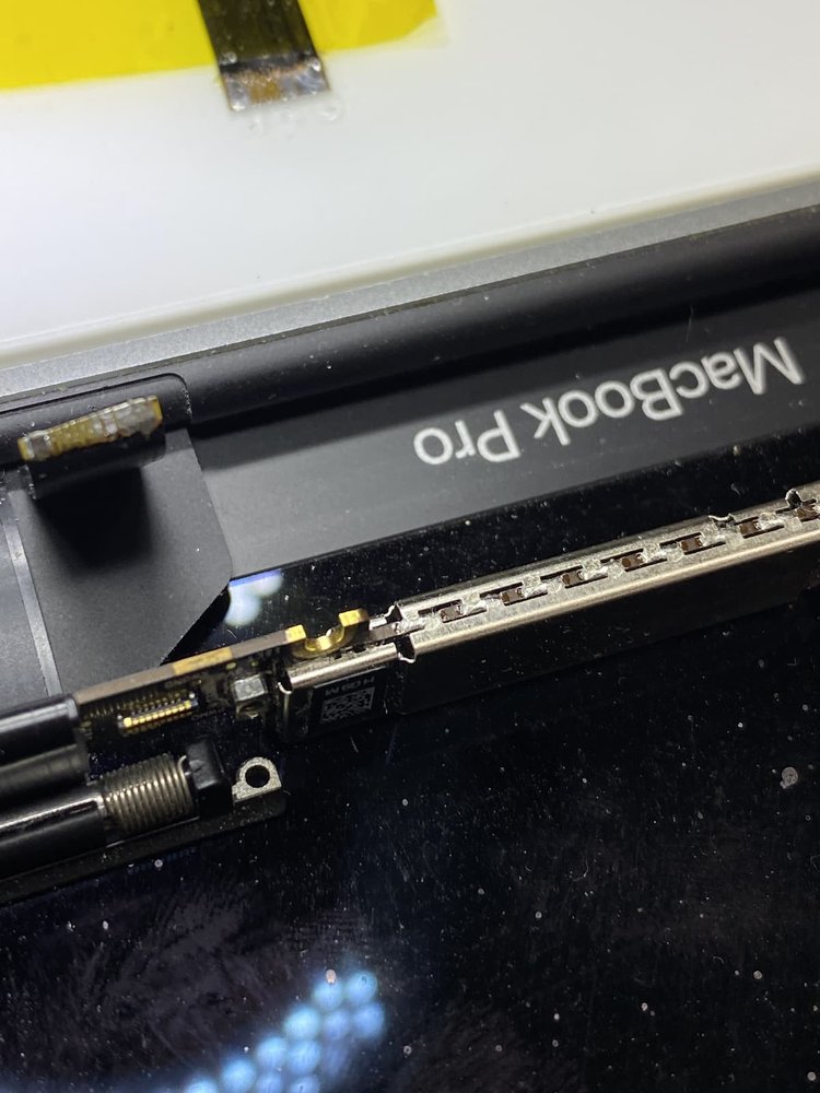 Closeup of cable repair for flexgate issue on Macbook Pro