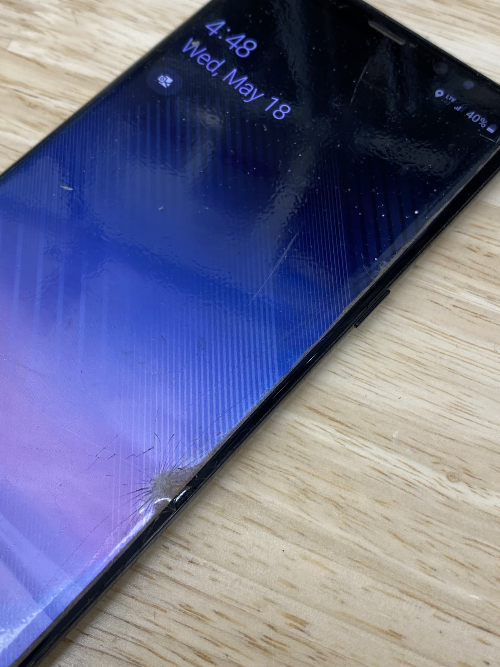 Cracked screen on Samsung Galaxy Note 8 with phone on.