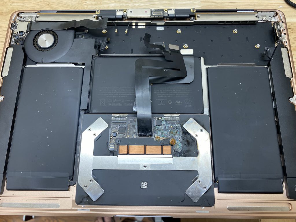MacBook Air with logic board and trackpad removed.
