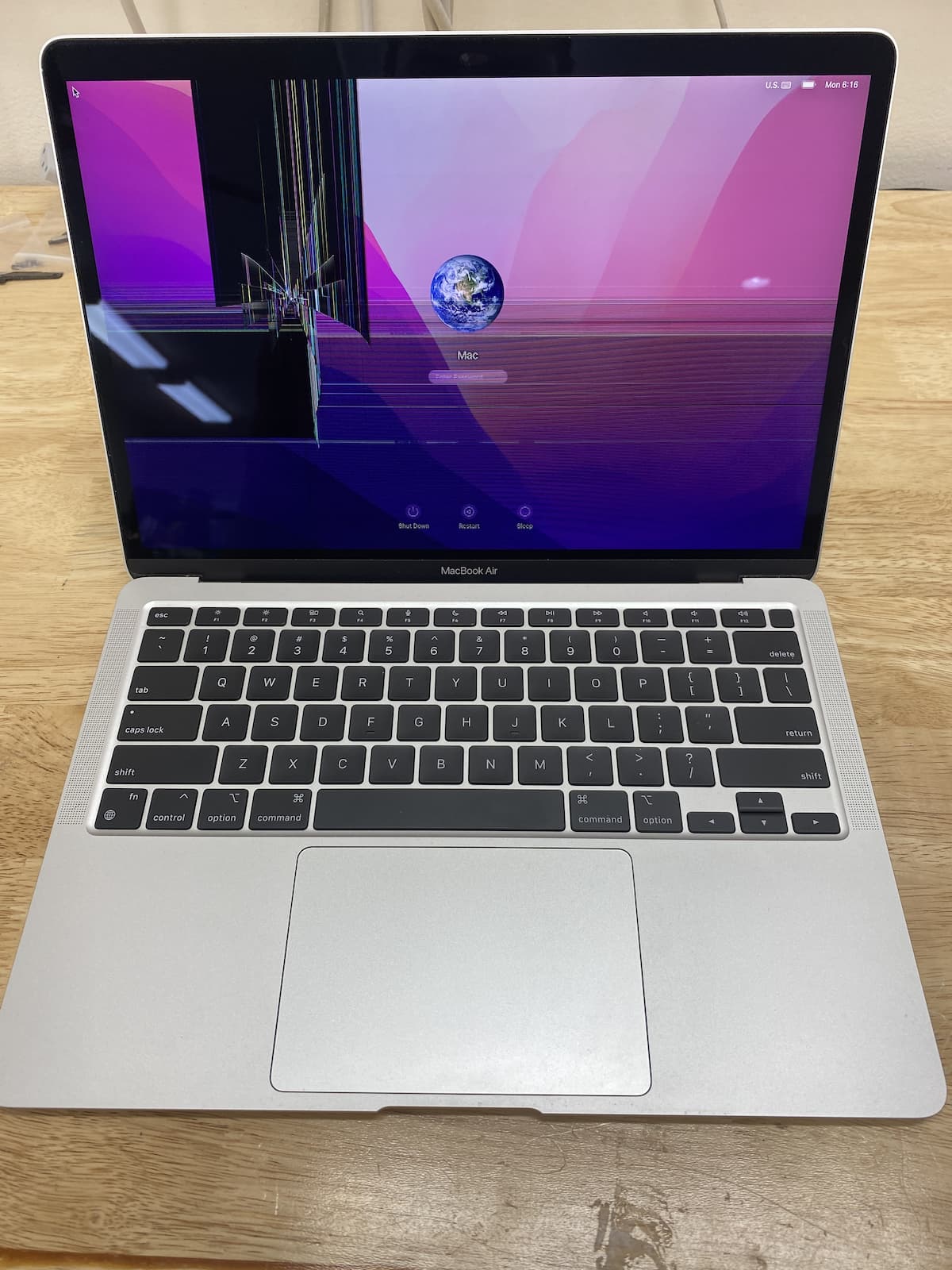 MacBook Air with cracked screen.