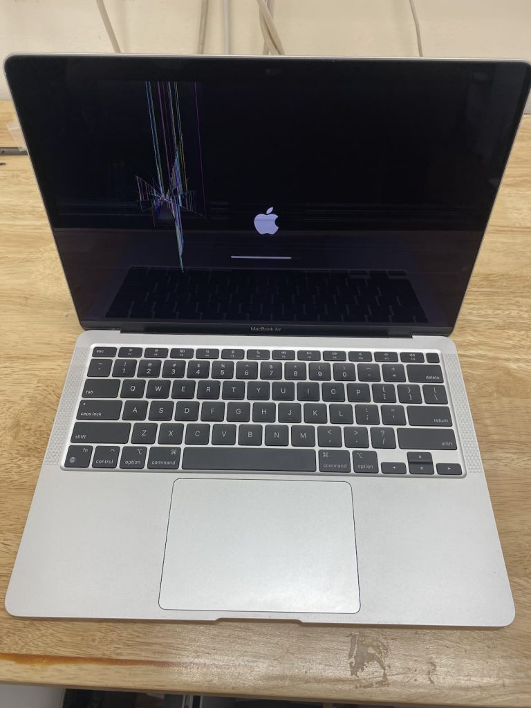 MacBook Air booting with cracked screen present.