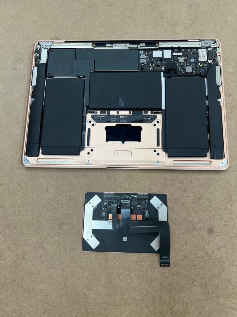 MacBook Air with liquid damaged trackpad removed.